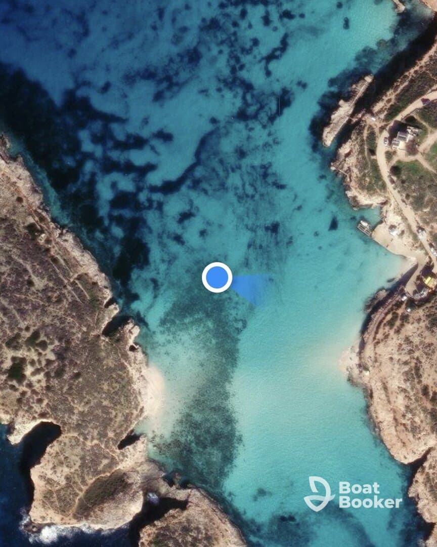 Aerial view of a coastal area with clear turquoise waters and rocky shorelines, but the image lacks clarity and detail.