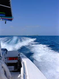A dynamic view from the helm of a speedboat cutting through vibrant blue waters, showcasing the thrill of boating adventures.