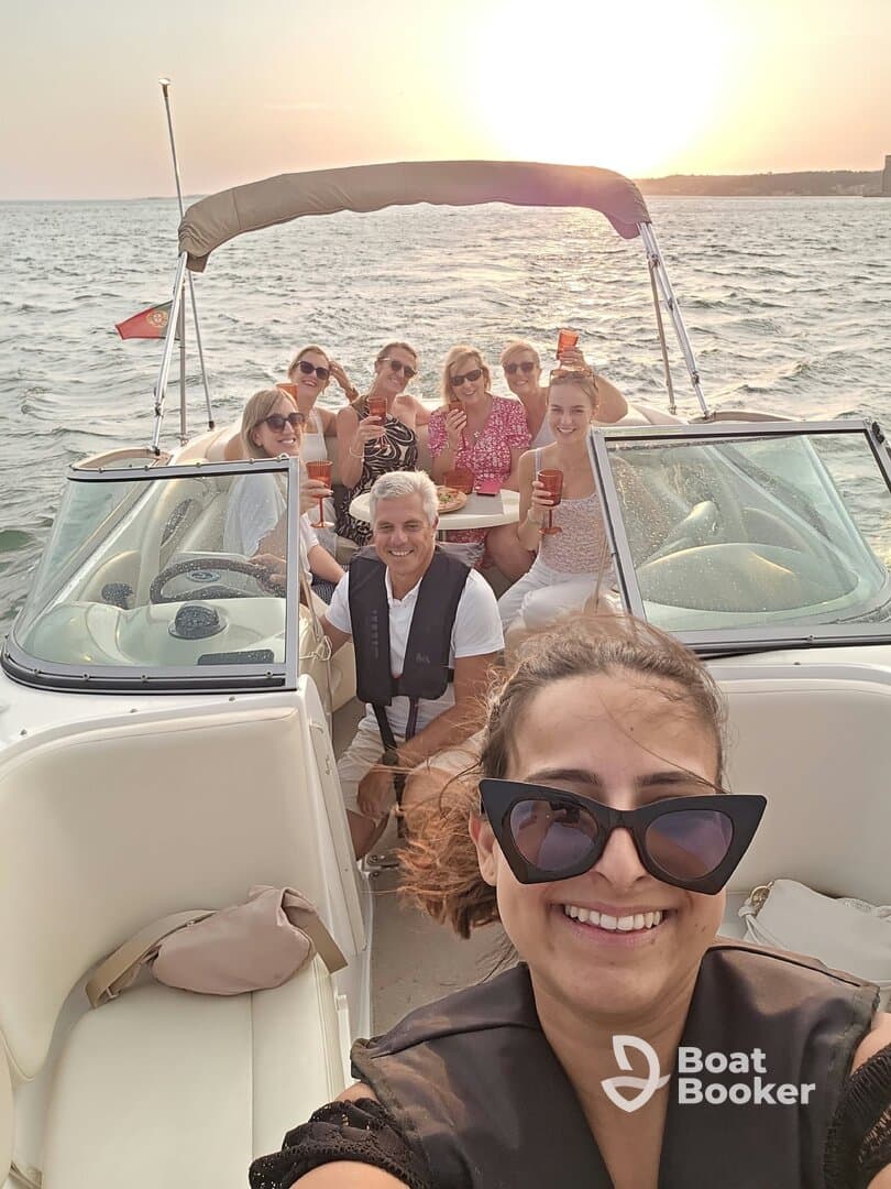 A lively group enjoys a sunset boat party, raising cocktails and celebrating together — perfect for memorable gatherings on the water.
