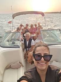 A lively group enjoys a sunset boat party, raising cocktails and celebrating together — perfect for memorable gatherings on the water.