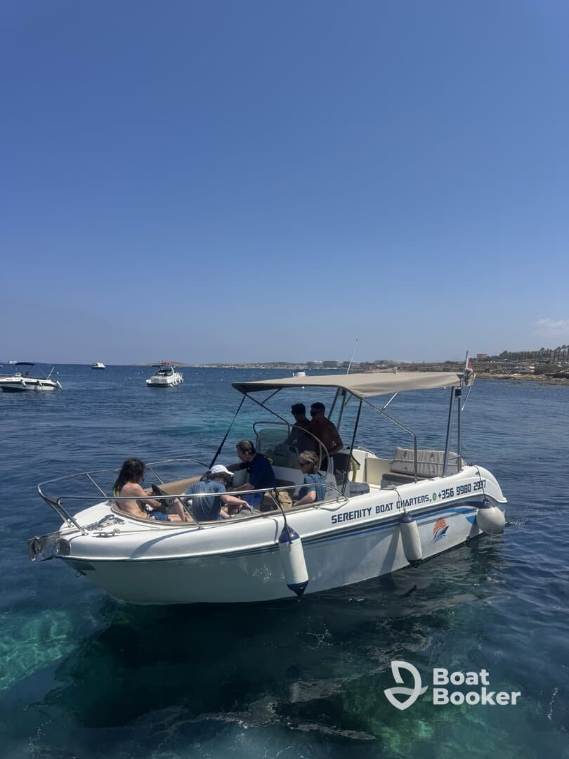 A lively group enjoys a day on the water aboard Serenity Boat Charters, perfect for swimming and relaxation under the sun.