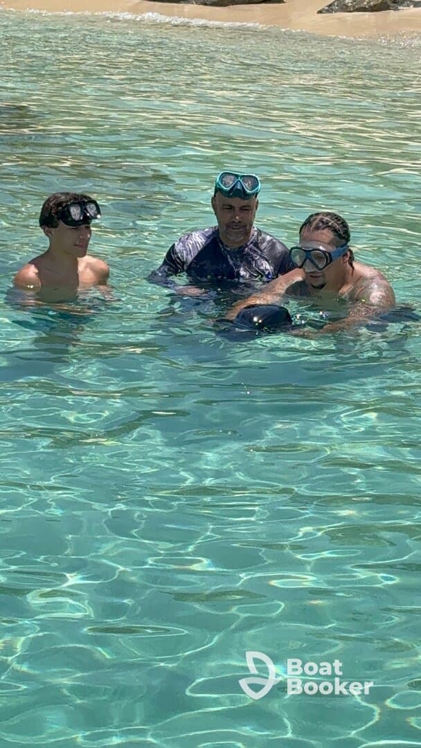 A group of snorkelers enjoy the clear waters, showcasing a fun underwater adventure experience perfect for family outings.