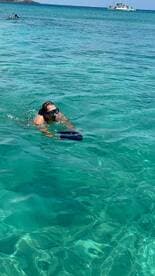 A snorkeler explores the vibrant underwater world in crystal-clear waters, showcasing the excitement of aquatic adventures.
