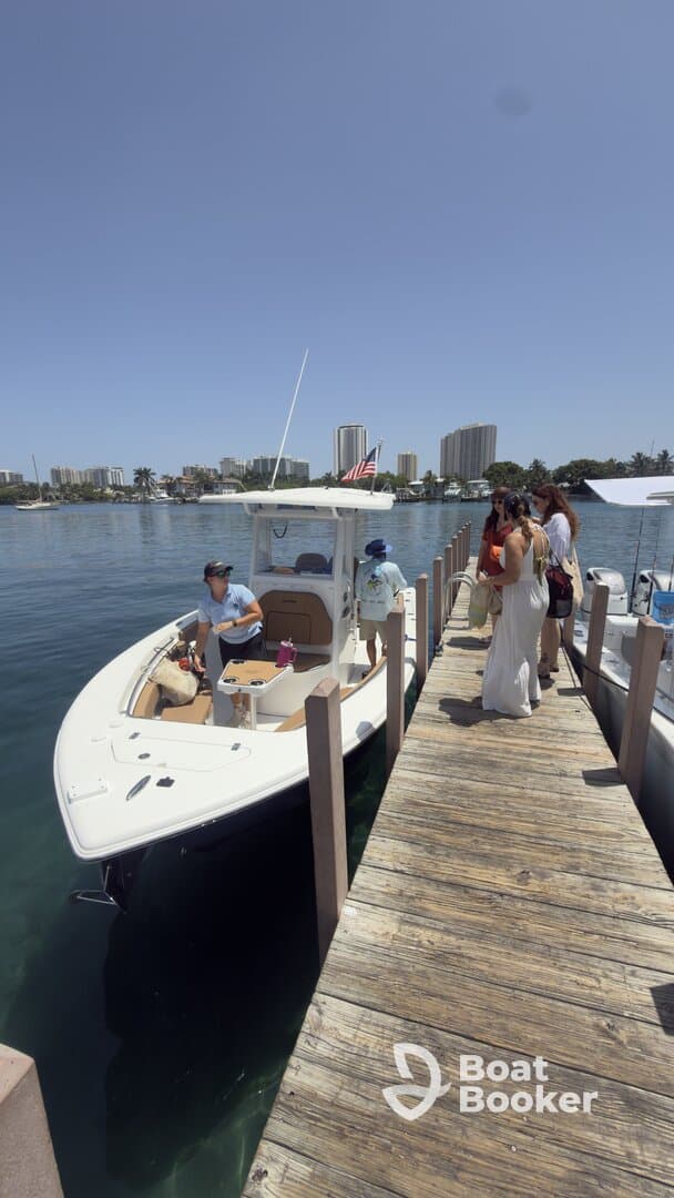 A group of friends boards a boat at the dock, ready for a day of adventure on the water. The vibrant setting and camaraderie highlight the excitement of a boating trip.