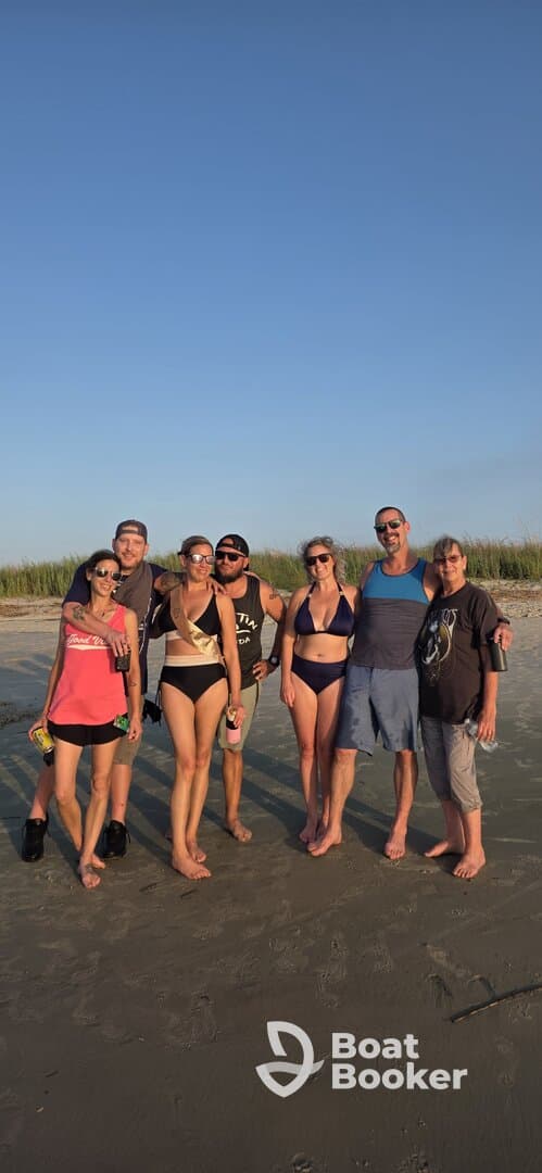 A lively group of friends enjoys a beach day, celebrating together with drinks and smiles — perfect for memorable summer outings.
