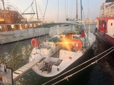 A sleek sailboat docked at the marina, showcasing its elegant design and inviting atmosphere for private trips.
