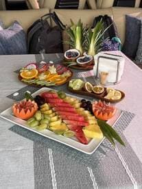 A beautifully arranged fruit platter featuring a variety of fresh fruits, perfect for enjoying on a boat trip. Ideal for catering or snack options while cruising.