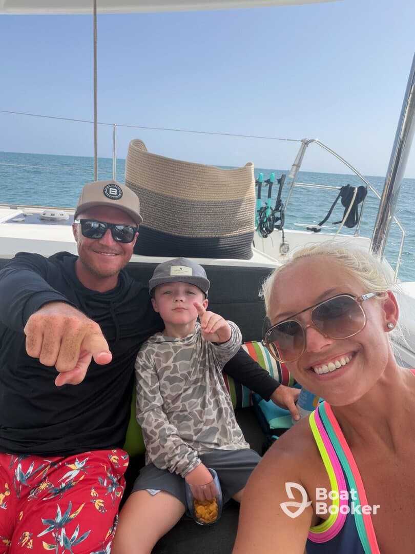 A joyful family moment aboard a boat, capturing smiles and snacks while enjoying a day on the water.