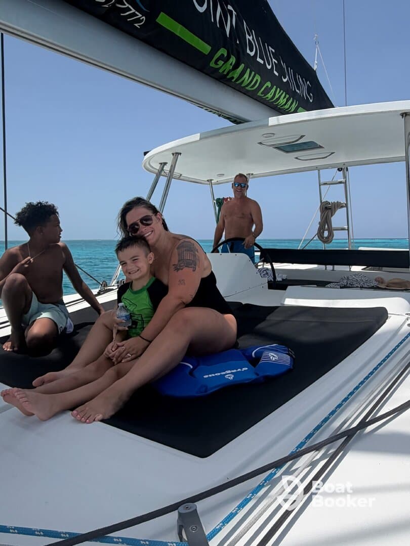 A joyful family enjoys a sunny day on a boat, creating lasting memories while relaxing on deck — perfect for family outings in beautiful waters.