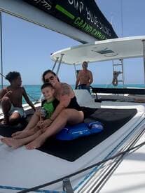 A joyful family enjoys a sunny day on a boat, creating lasting memories while relaxing on deck — perfect for family outings in beautiful waters.