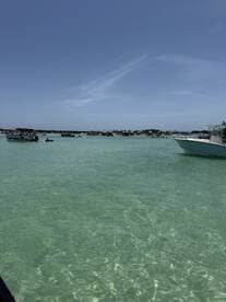 A vibrant scene of boats anchored in crystal-clear turquoise waters, showcasing a lively atmosphere perfect for a day of fun on the water.