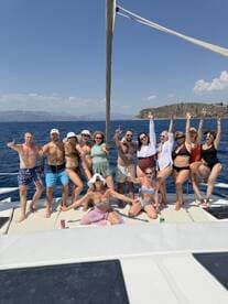 A lively group of friends celebrates aboard a yacht, enjoying the sun and sea — perfect for unforgettable summer parties and gatherings.