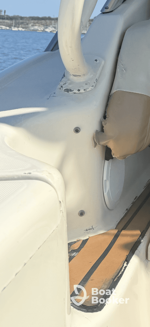 Interior view of a boat's seating area, showcasing the helm and upholstery details, ideal for comfortable cruising.