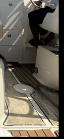 A glimpse of the interior helm area of a boat, showcasing the seating and control panel, perfect for navigating the waters.
