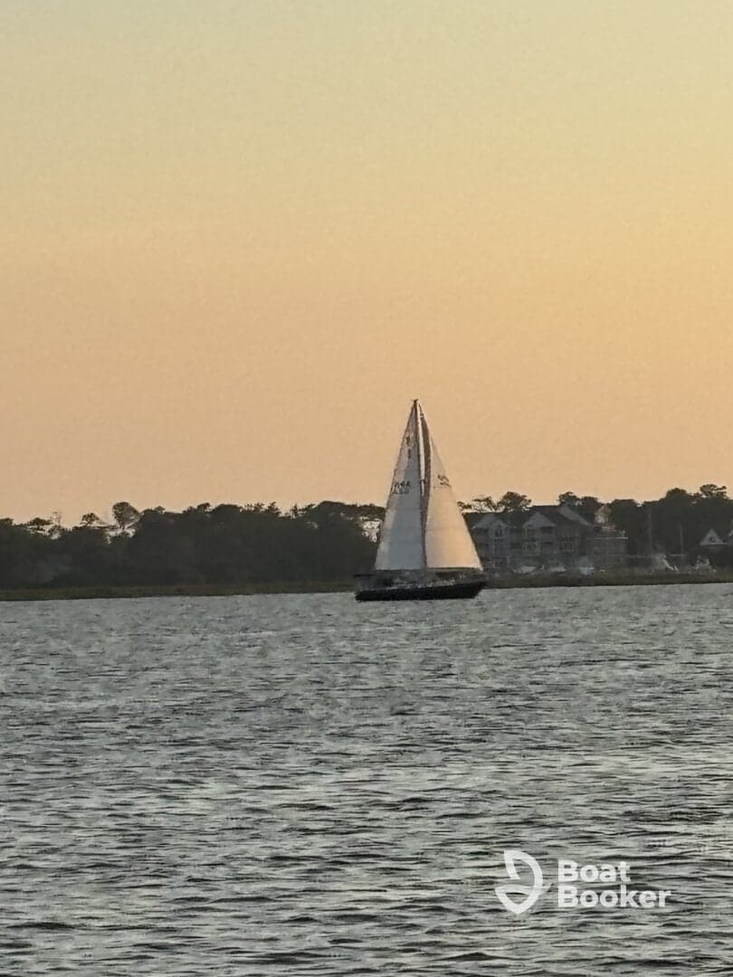 A beautiful sailboat glides across the water at sunset, showcasing the serene beauty of sailing adventures.