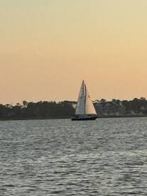 A beautiful sailboat glides across the water at sunset, showcasing the serene beauty of sailing adventures.