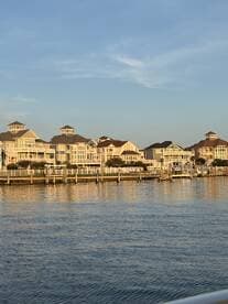 A scenic view of waterfront homes along a calm waterway, capturing the essence of coastal living.