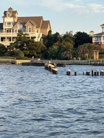 A view of a waterfront scene featuring a house and a dock, but the focus is unclear and lacks identifiable subjects.