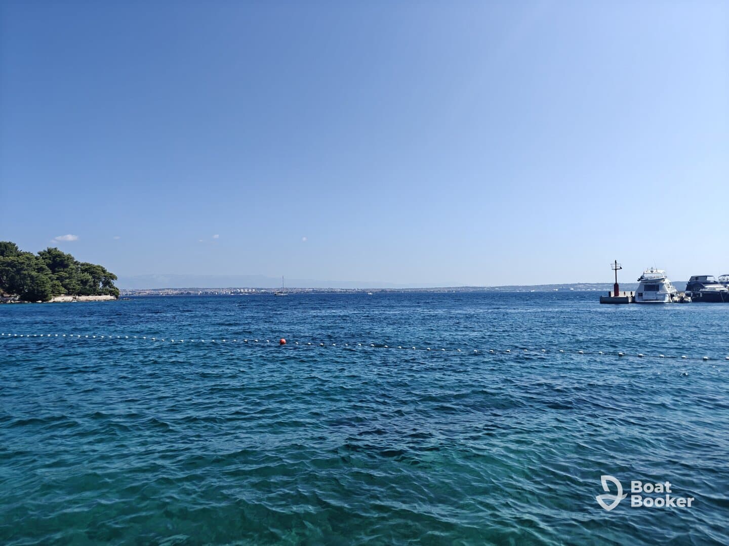 A scenic view of calm waters and distant land, showcasing a peaceful maritime environment.