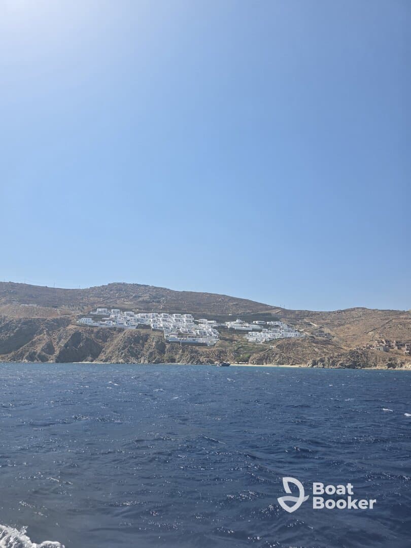 A stunning view of a coastal hillside with white buildings, showcasing the beautiful scenery of the island — perfect for travelers seeking picturesque destinations.