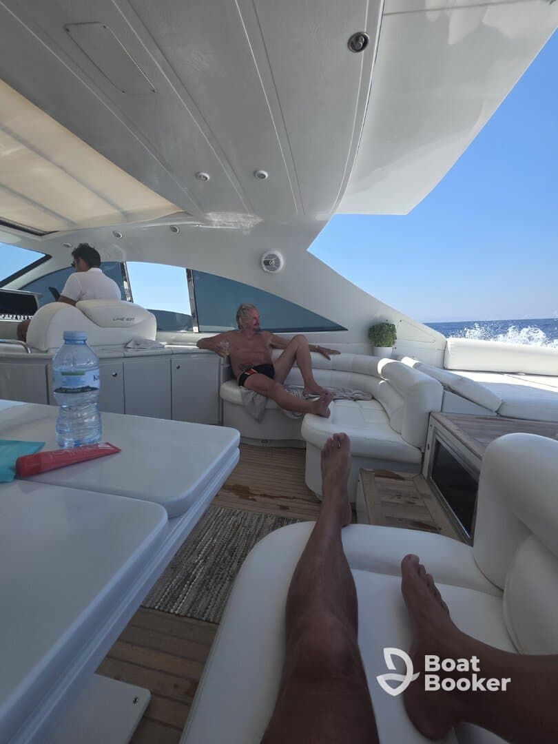 Relaxing interior of a luxury yacht featuring comfortable seating and a serene atmosphere, perfect for enjoying a day on the water.