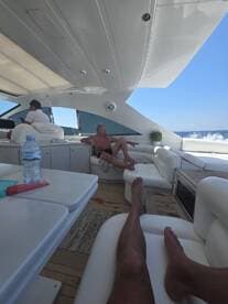 Relaxing interior of a luxury yacht featuring comfortable seating and a serene atmosphere, perfect for enjoying a day on the water.