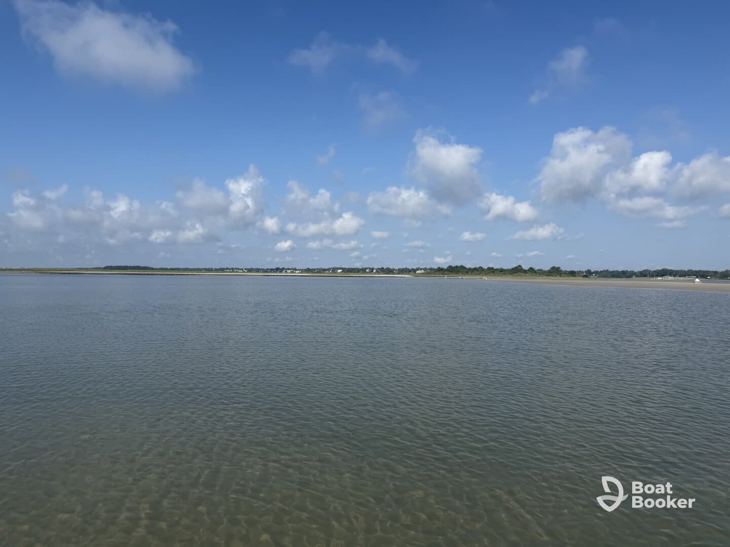 A scenic view of calm waters and a cloudy sky, capturing the tranquility of the landscape.
