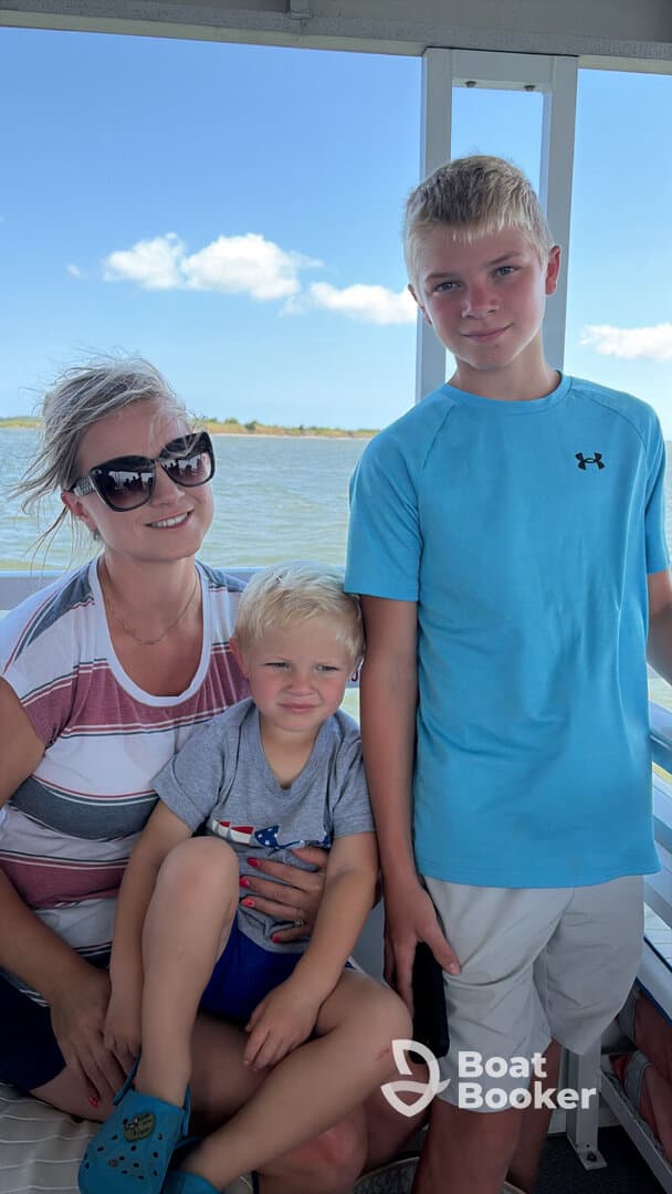 A family enjoys a day on the boat, capturing a moment with two children, perfect for creating lasting memories on the water.