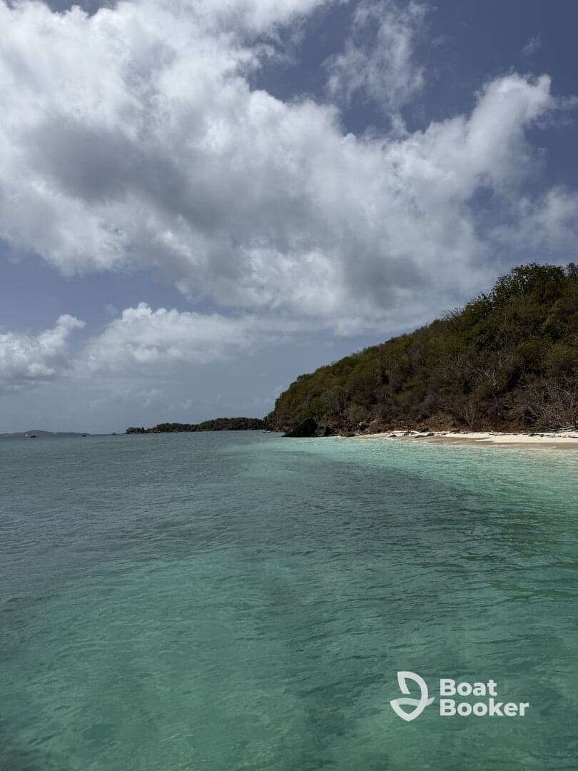 A stunning view of a serene coastline with crystal-clear waters and lush greenery, perfect for showcasing the beauty of tropical destinations.