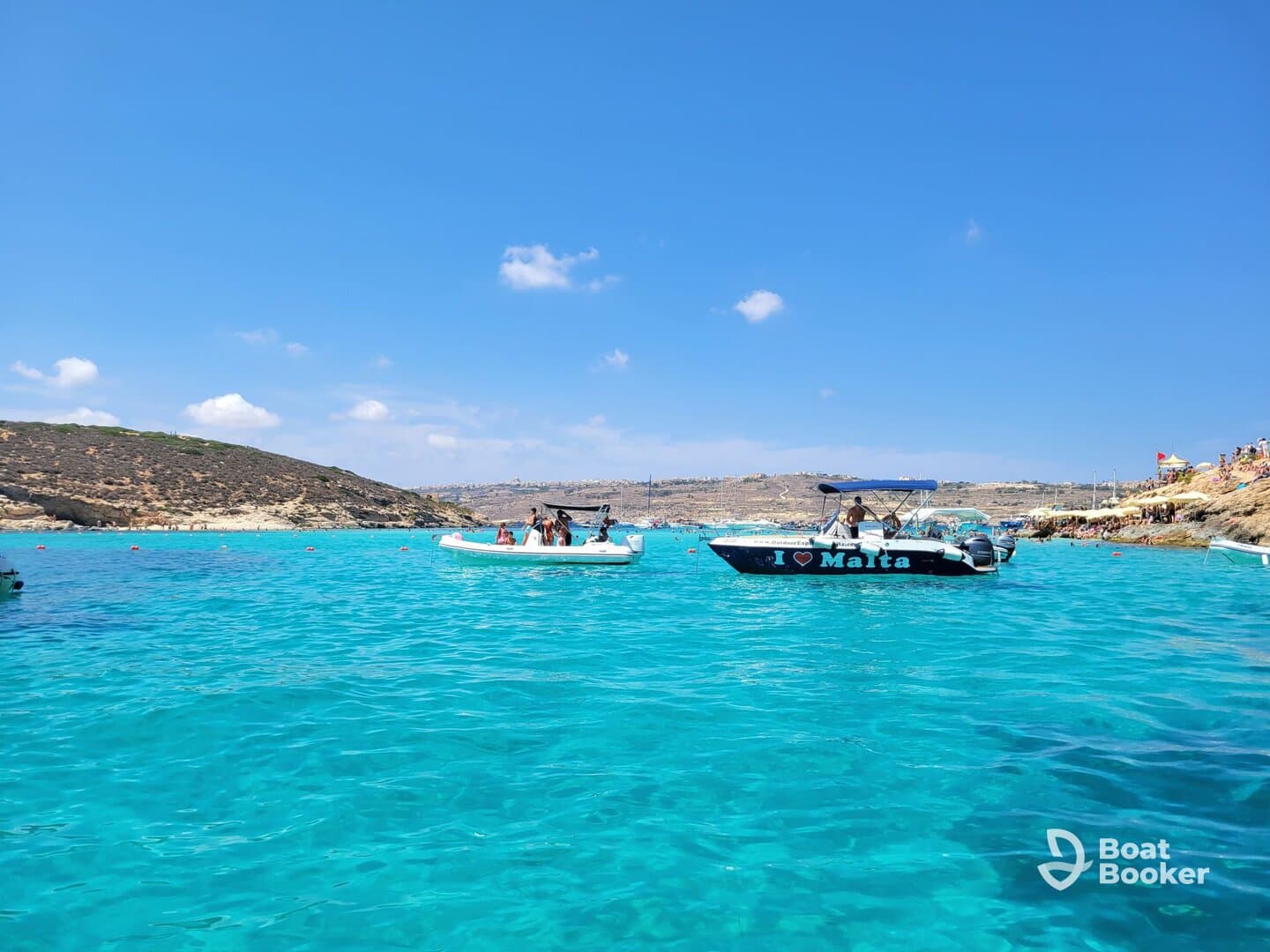 A vibrant scene in Malta showcasing boats on crystal-clear turquoise waters, perfect for a day of exploration and fun in the sun.