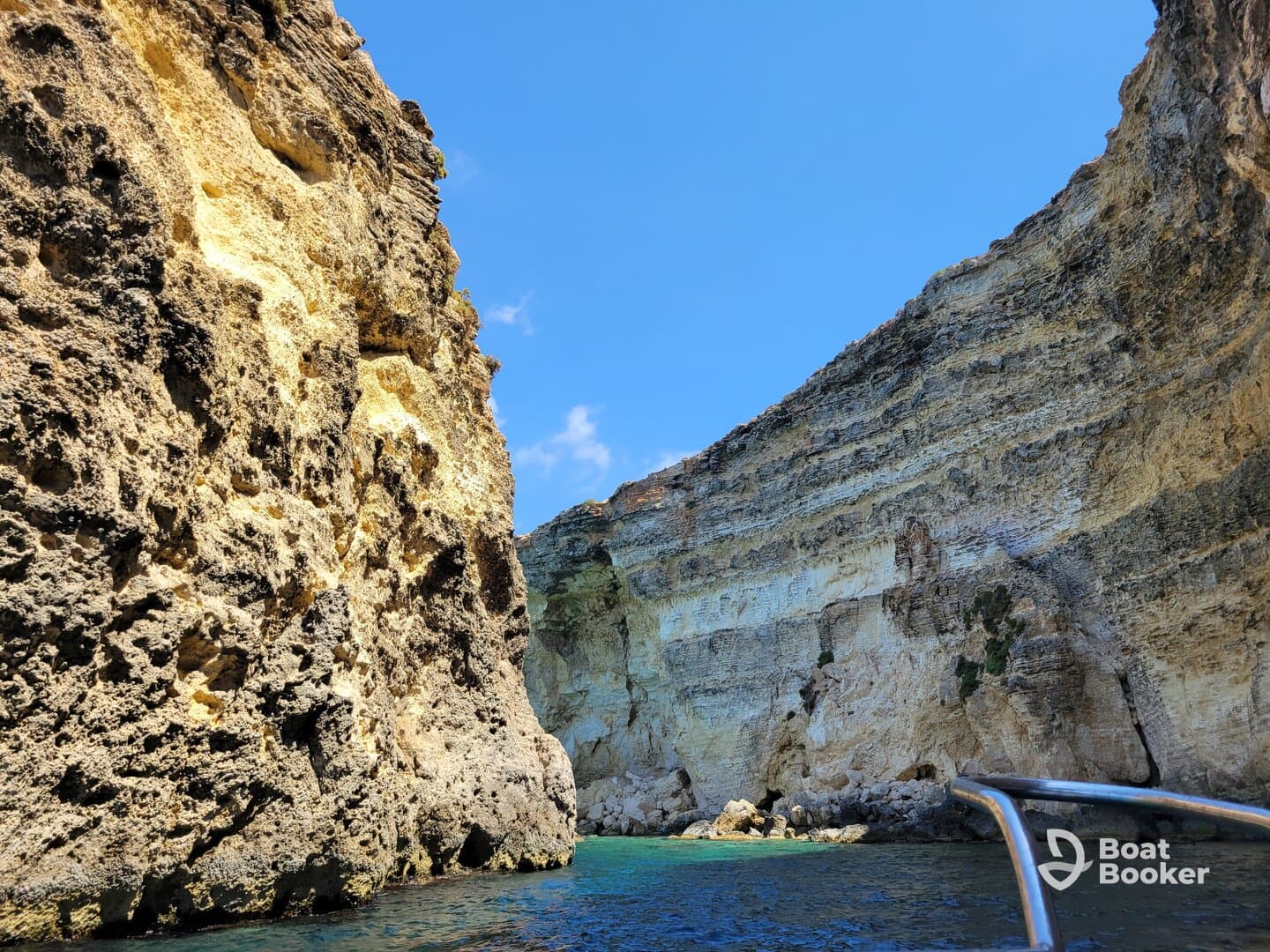 A stunning view of dramatic rock formations along the coastline, showcasing the natural beauty of the area — perfect for scenic boat tours.