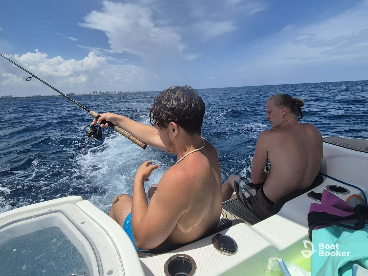 Two friends enjoy a fishing trip on a boat, casting lines into the open ocean — a perfect day for adventure and camaraderie on the water.