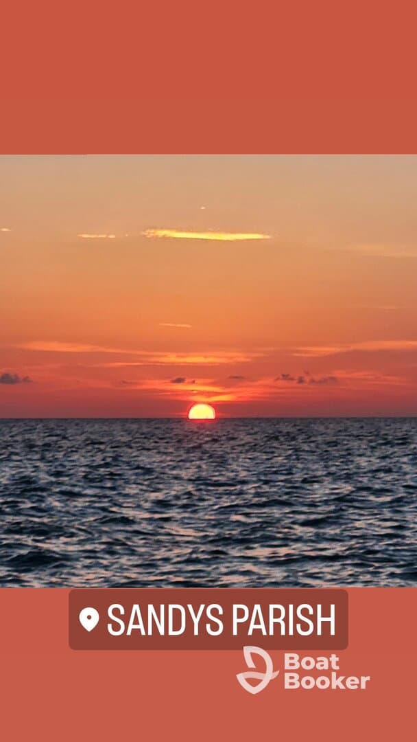 A stunning sunset over the ocean near Sandys Parish, creating a picturesque backdrop perfect for romantic evenings or tranquil boat rides.