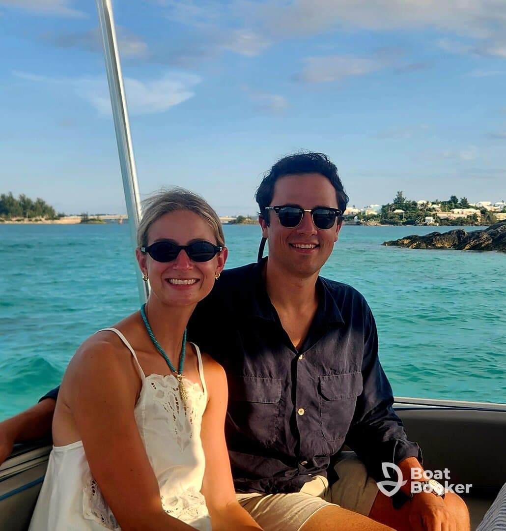 A cheerful couple enjoys their time on a boat, surrounded by beautiful ocean views — perfect for a romantic getaway or vacation adventure.