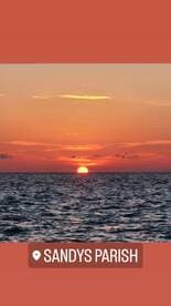 A stunning sunset over the ocean near Sandys Parish, creating a picturesque backdrop perfect for romantic evenings or tranquil boat rides.