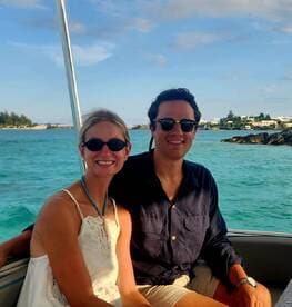 A cheerful couple enjoys their time on a boat, surrounded by beautiful ocean views — perfect for a romantic getaway or vacation adventure.