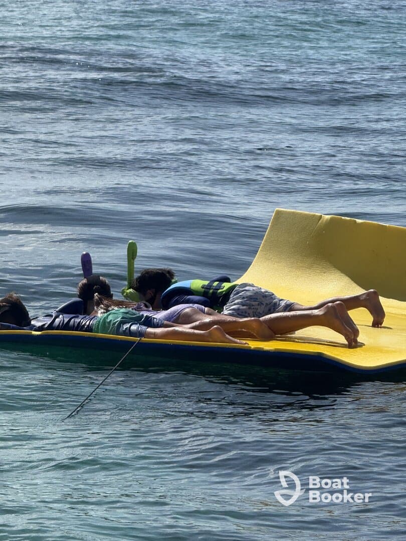 A group of children enjoys a fun day on a floating mat in the water, showcasing the perfect summer activity for families and friends.