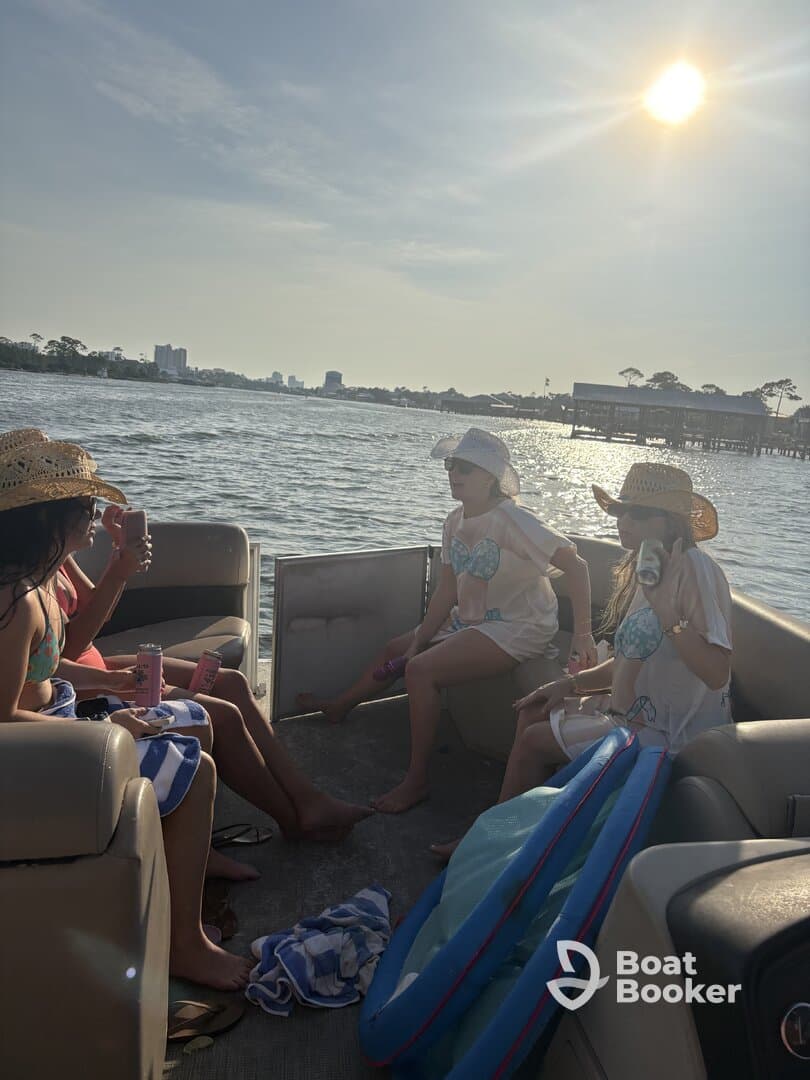 A lively group enjoys drinks and sunshine aboard a pontoon boat, creating unforgettable memories on the water.