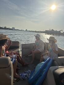 A lively group enjoys drinks and sunshine aboard a pontoon boat, creating unforgettable memories on the water.