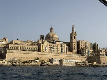 A stunning view of the historic skyline of Valletta, Malta, showcasing its iconic architecture along the coastline — perfect for sightseeing and cultural exploration.