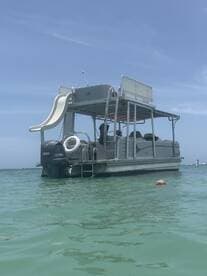 A fun-filled day on a pontoon boat with a child enjoying the water, showcasing the perfect setting for family adventures and water activities.