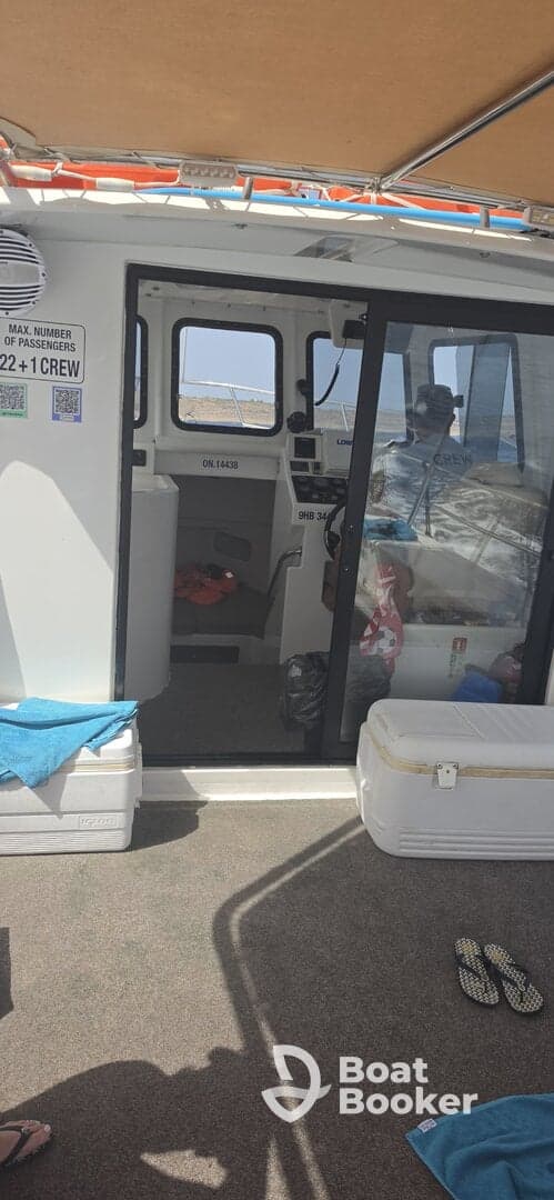 Interior view of a boat's helm and cabin area, showcasing the console and seating arrangements — ideal for navigation and comfort while on the water.
