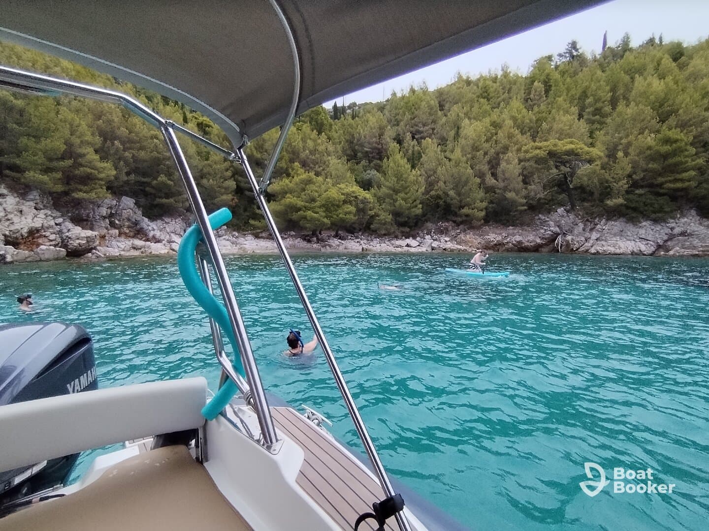 Guests enjoy a refreshing day of snorkeling and paddleboarding in crystal-clear turquoise waters, surrounded by stunning natural scenery.