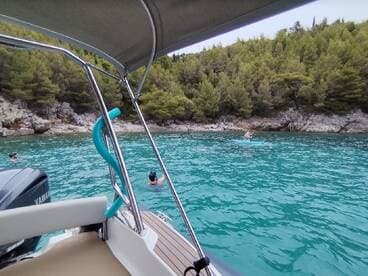 Guests enjoy a refreshing day of snorkeling and paddleboarding in crystal-clear turquoise waters, surrounded by stunning natural scenery.