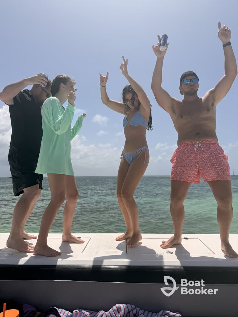 A lively group enjoys a fun moment on the boat, dancing and celebrating under the sun — perfect for unforgettable boat parties.