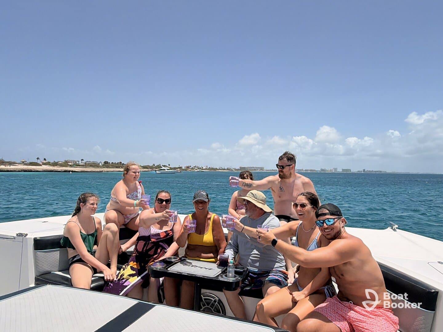 A lively group enjoys drinks and laughter aboard a pontoon boat, capturing the essence of a fun-filled day on the water.