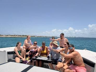 A lively group enjoys drinks and laughter aboard a pontoon boat, capturing the essence of a fun-filled day on the water.