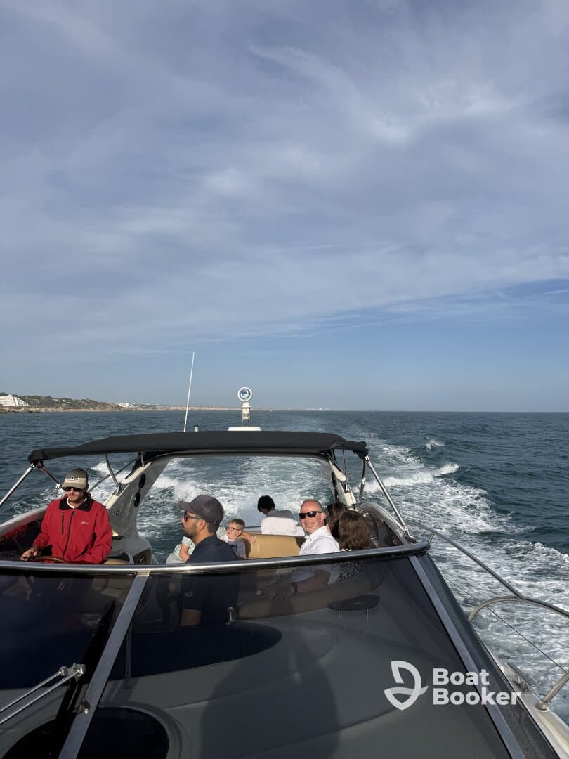 A lively group enjoys a boat ride, with smiles and conversation as they cruise through the water — perfect for family outings or group adventures.