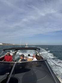 A lively group enjoys a boat ride, with smiles and conversation as they cruise through the water — perfect for family outings or group adventures.