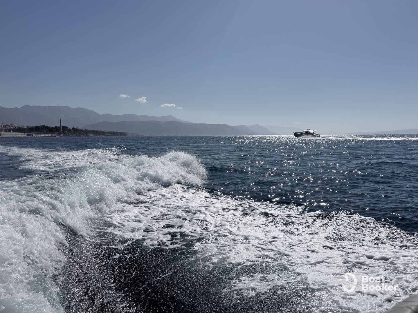 A stunning view of a yacht cruising through sparkling ocean waters, showcasing the beauty of a day on the sea.